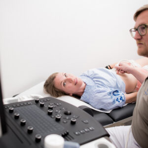 Dr. Thorsten Schmidt führt am Bauch einer Patientin einen Ultraschall durch